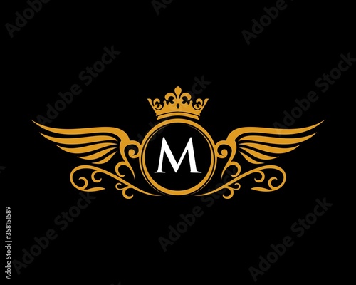 M letter initial with wings and crown crest
