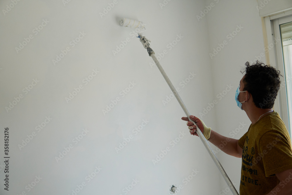 Painter painting a room