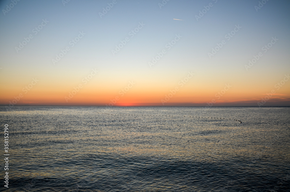 Beautiful orange sunrise on the Mediterranean Sea shore at Olympos coast, Cirali village, Turkey