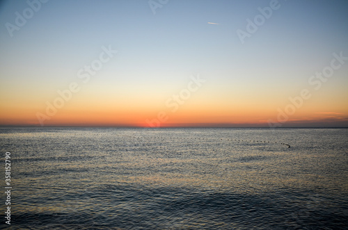 Beautiful orange sunrise on the Mediterranean Sea shore at Olympos coast, Cirali village, Turkey