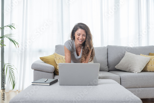 Young freelancer worker woman or girl reading and preparing the new business contract and plan from her laptop taking notes to make a new project for the boss and company