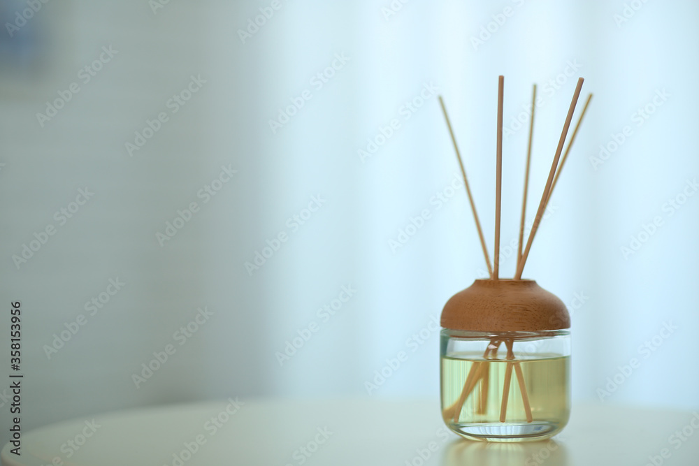 Aromatic reed air freshener on table indoors. Space for text Aromatic reed air freshener on table indoors. Space for text