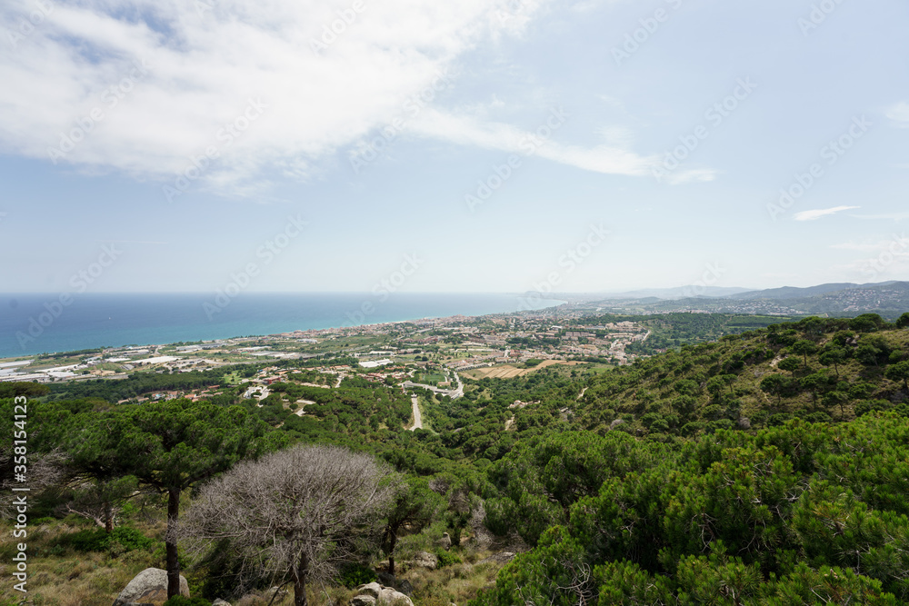 Panoramic view of Barcelona and the Maresme. Made from Premia de Dalt. Sunny day with some decorative clouds. - obrazy, fototapety, plakaty 