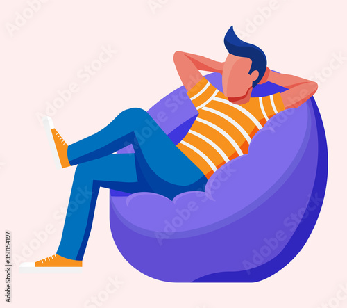 Young man sitting and chilling on bean bag. Man is resting in bag chair. Freelancer relaxing after work. Hipster character in jeans and t-shirt. Flat vector illustration photo