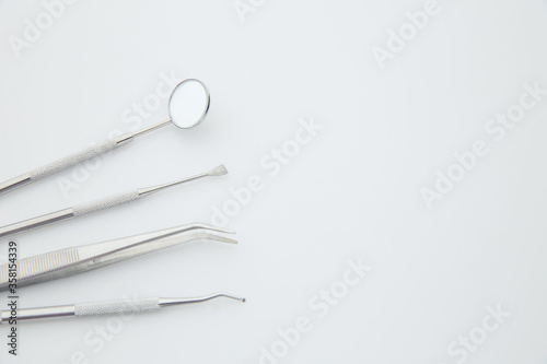Basic dentist tools isolated on white background. Dental health and teethcare concept. © burdun