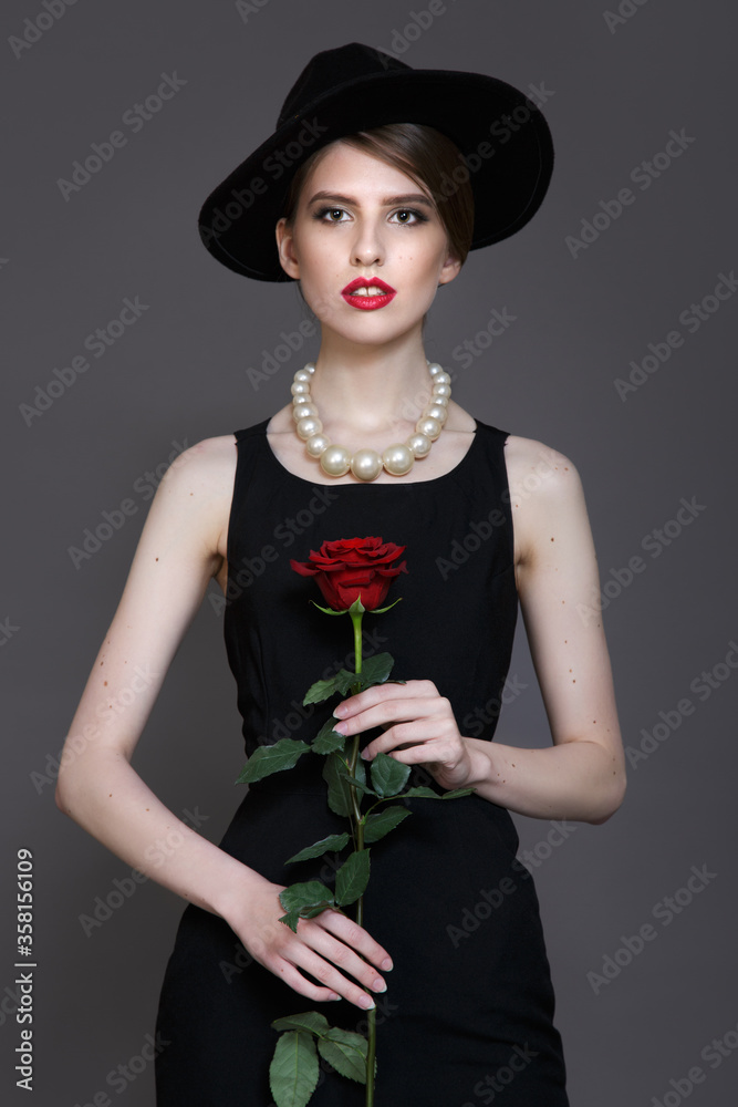 Fototapeta premium Woman vintage hat dress and rose. Portrait photo straight