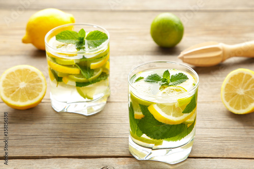 Cold fresh lemonade drink on a grey wooden background