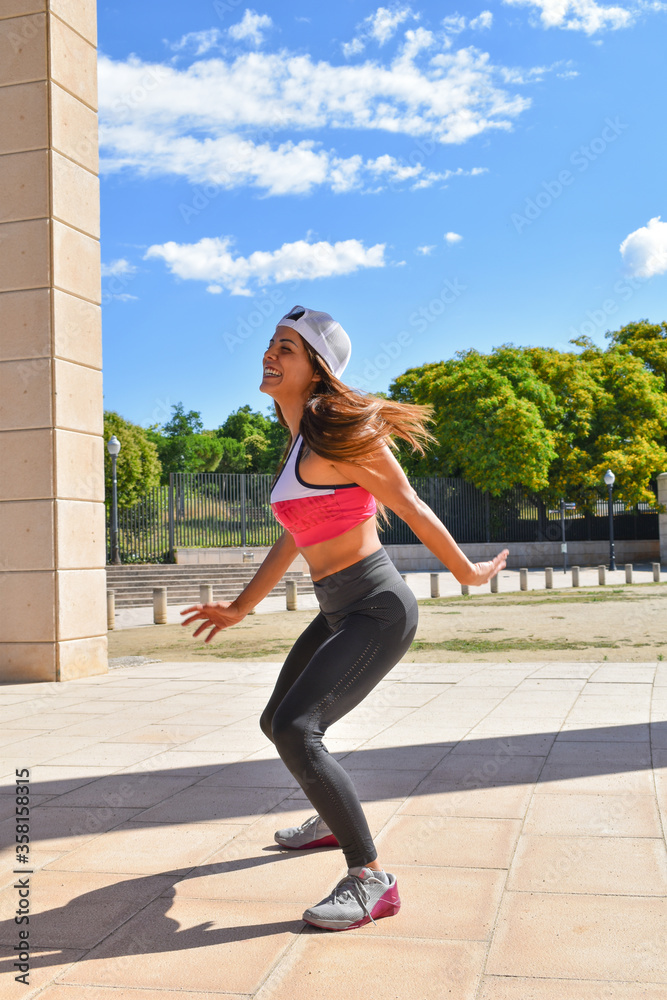 Young athlete woman, happy and laughing in the park on a sunny day