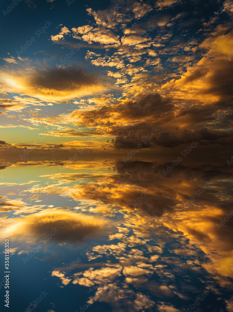 Reflections of clouds during sunset. Symmetrical illustration, resource for designers.