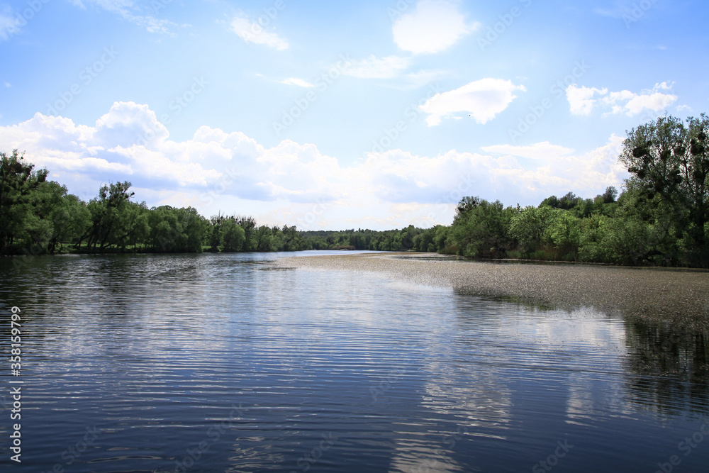 Beautiful river in the highlands in summer. Lake in an ecologically clean park reserve on a background of hills. A pretty landscape in the spring. Stock photo for design