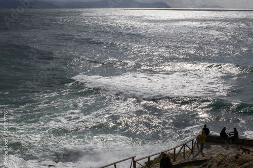 People near the sea waves