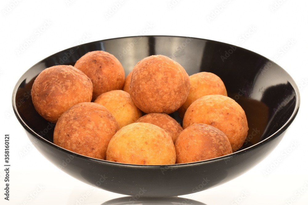 Fresh aromatic, cheese donuts in a black ceramic plate, close-up, on a white background. Fresh aromatic, cheese donuts in a black ceramic plate, close-up, on a white background.