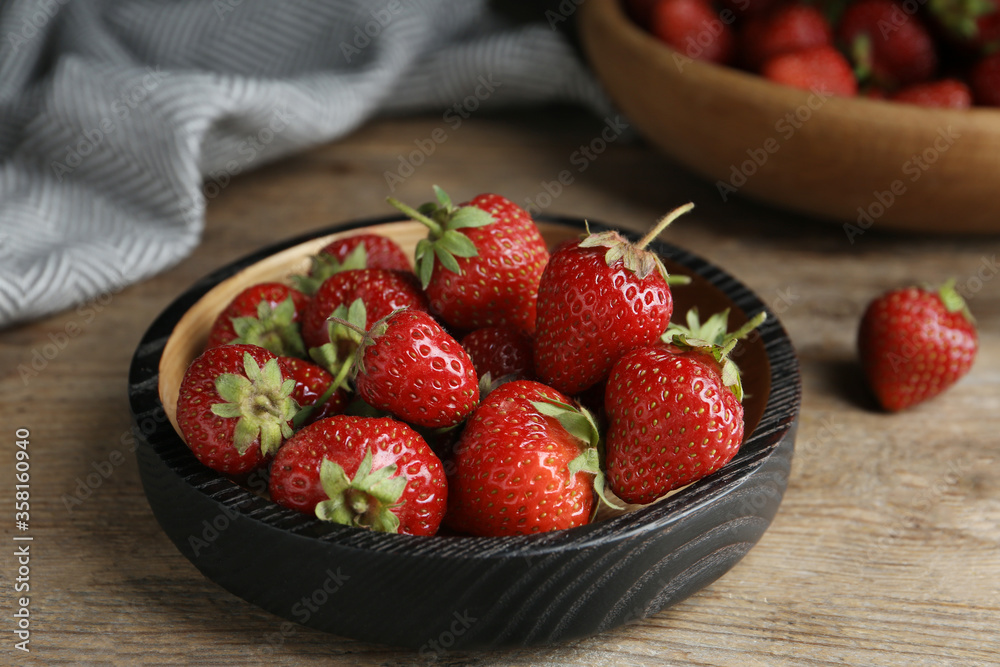 Delicious ripe strawberries on wooden plate, closeup Delicious ripe strawberries on wooden plate, closeup