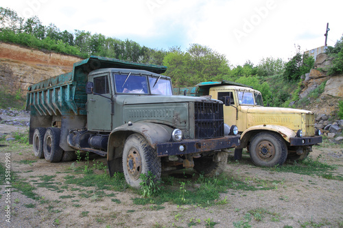 Old truck in very poor condition. A car stands in nature like abandoned metal rubbish. Stock photo background for design.