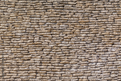 antique wall of rough brown stone