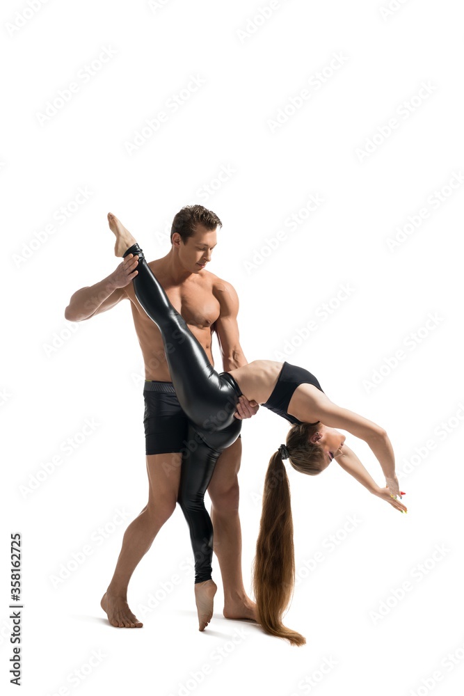 Fototapeta Young couple doing acrobatics isolated shot