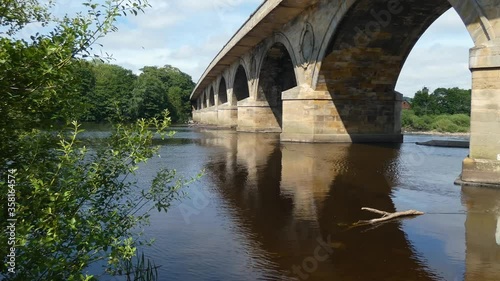 running water under a bridge on a sunny day photo