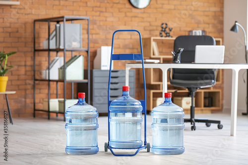 Cart with bottles of fresh water in office photo