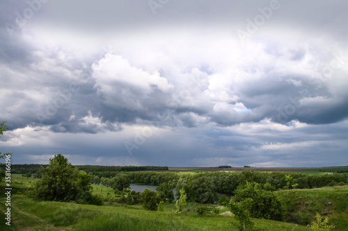 Beautiful summer landscape of nature countryside. Green vegetation of grass and trees with hills. Stock photo for design