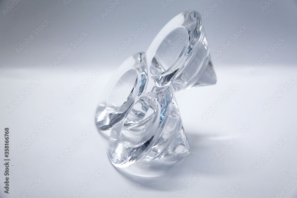 A transparent glass candlestick with a support base and the top of which has three nozzles where the candles are placed to light. A transparent glass candlestick with a support base and the top of which has three nozzles where the candles are placed to light.
