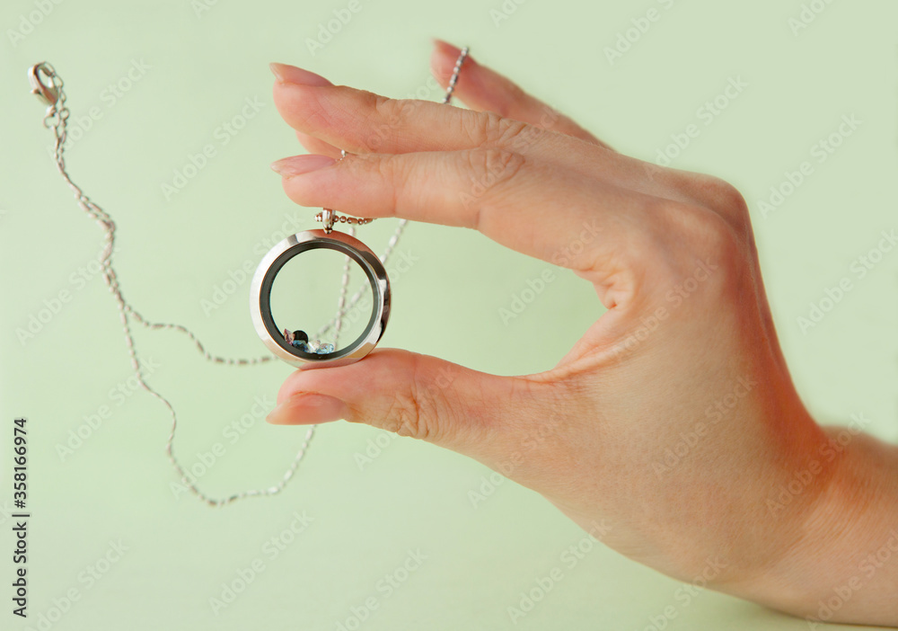Silver necklace for her shining on womans hand. Luxury silver jewelry chains with glass and crystals. Small Beautiful precious metal present for woman. Luxury jewelry gift Silver necklace for her shining on womans hand. Luxury silver jewelry chains with glass and crystals. Small Beautiful precious metal present for woman. Luxury jewelry gift