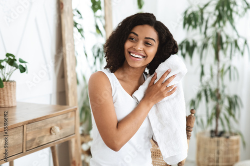 Home Haircare. Smiling African Woman Drying Wet Hair With Towel After Shower