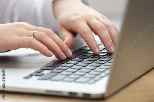 Woman hand working on a notebook using touchpad.