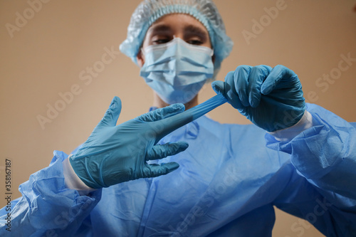 The nurse / doctor takes off the gloves. Pandemic 2019 nKoV. stop coronavirus. MERS. A virologist is thinking of a coronavirus vaccine. flu, bird flu. photo