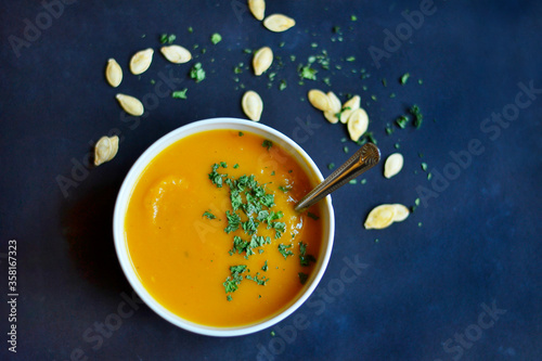 bowl of butternut sqaush soup with spoon