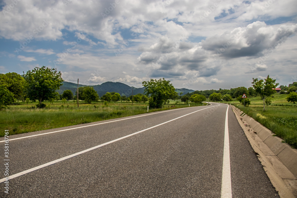 Asphalt road in countryside on sunny summer day in Vrancea region, Barsesti, Romania