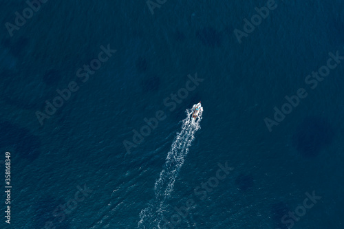Small fishing boat in the deep blue sea. Overhead view © kirill_makarov