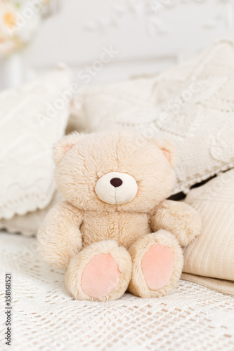 Vintage Teddy bear on a bed.