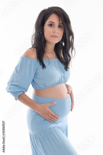 Happy smiling pregnant woman touching her belly isolated on white background. Pregnancy concept studio portrait Mother expecting baby. Baby tea.