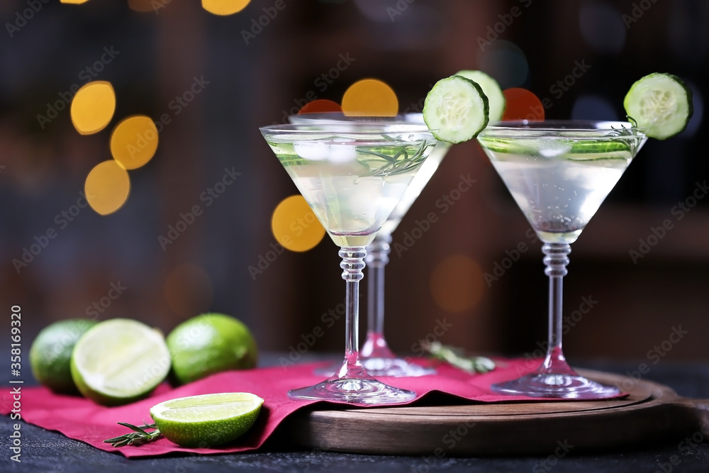 Glasses of tasty cucumber martini on table in bar