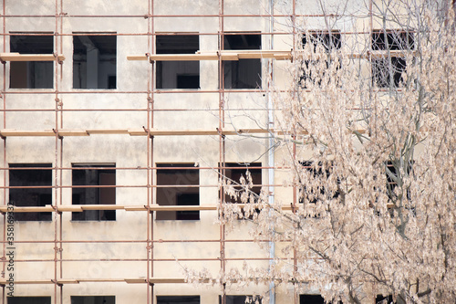 Scaffold on building facade under reconstruction photo