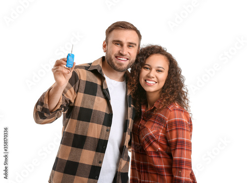 Happy young couple with car...