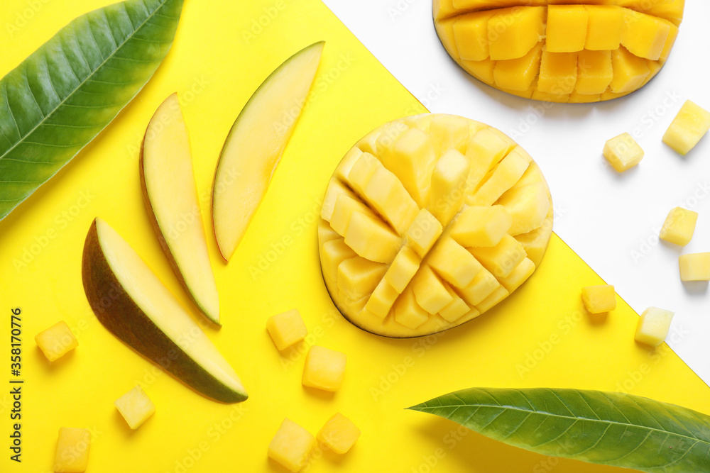 Flat lay composition with cut fresh ripe mango fruits on color background Flat lay composition with cut fresh ripe mango fruits on color background