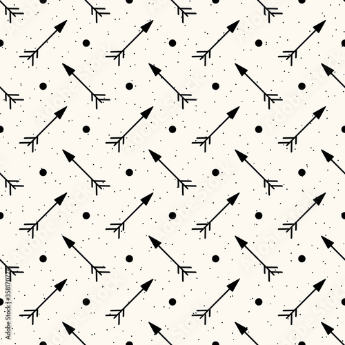 Vector seamless geometric pattern with hand drawn arrows and polka dot. Simple minimalistic pattern in north american indian ethnic style with tribal archery. Boho kid background.