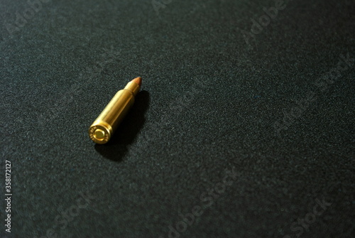 Weapon cartridge isolated on a dark background