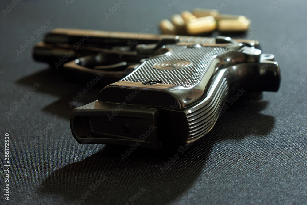 Pistol and ammunition on a dark background