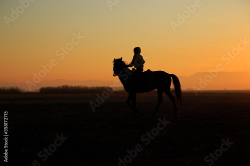 Silhouette view of a horseman at sunset. Cappadocia, Turkey © Suat