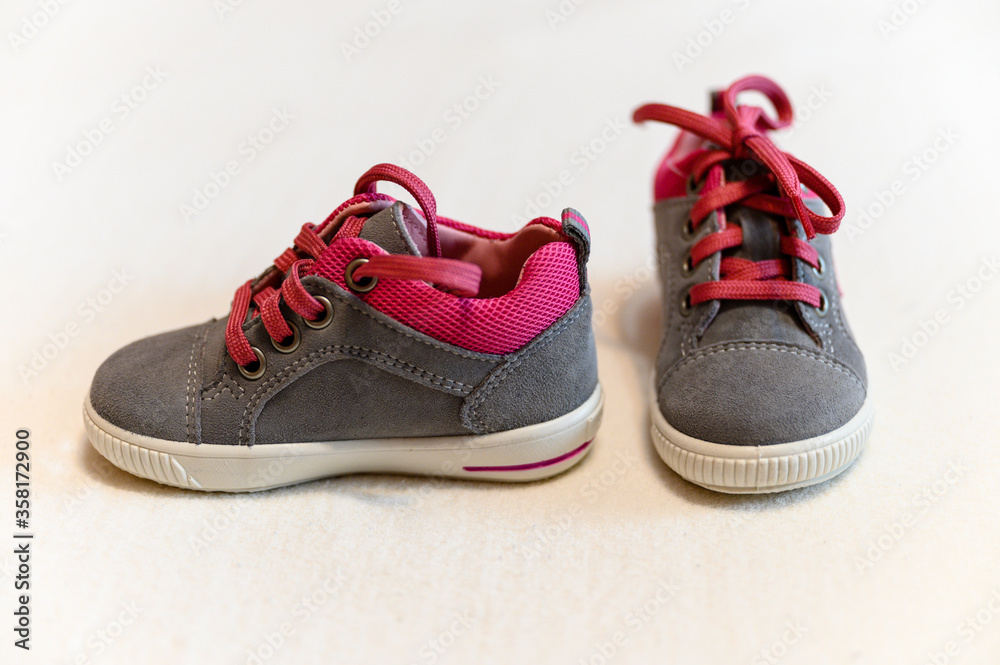 Children's leather shoes with a red lace.