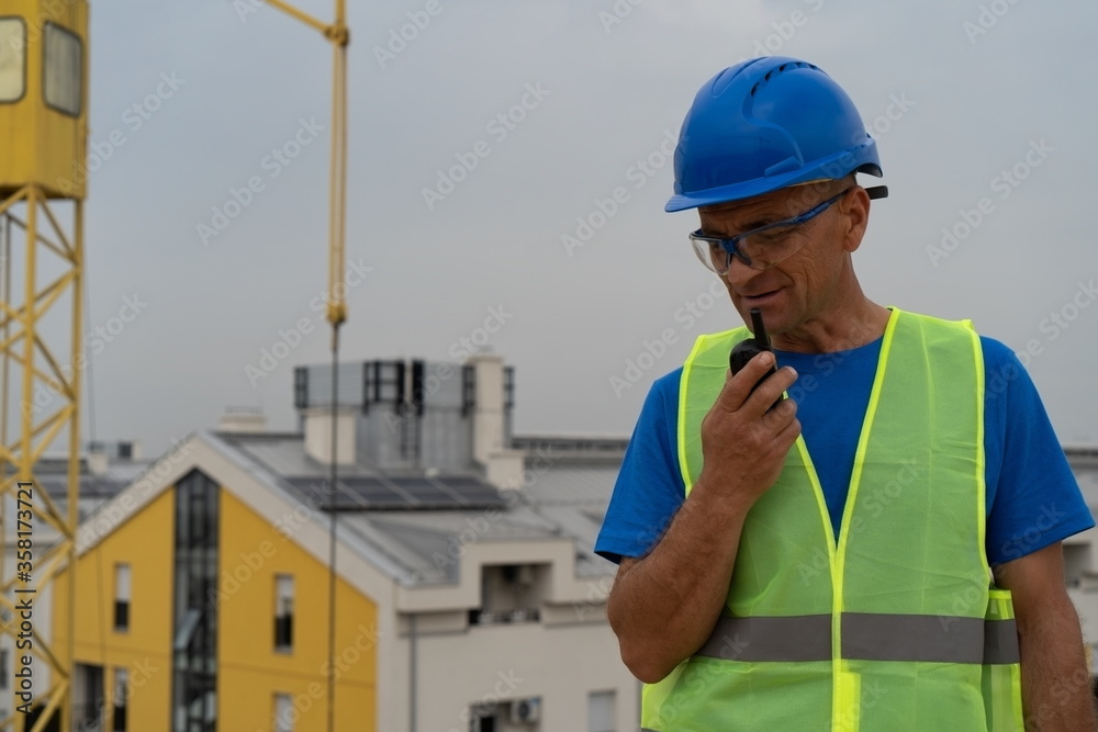 A construction site worker talking on a walkie-talkie stock image A construction site worker talking on a walkie-talkie stock image