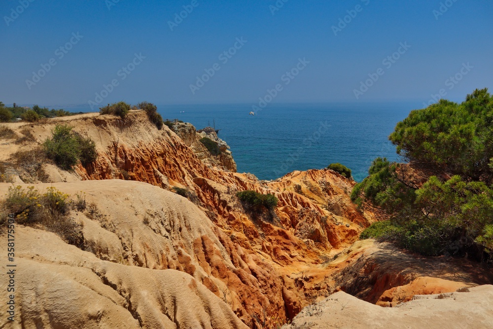 Sandstone Cliffs near Marinha Beach in Algarve Coast with Green Tree. South of Portugal and its Beauty.