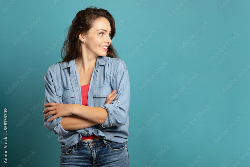 young woman smiling in profile and arms crossed