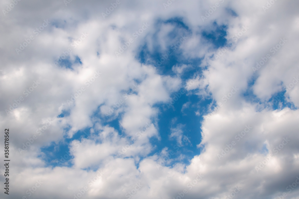 White clouds on a blue sky. Beautiful natural background. White clouds on a blue sky. Beautiful natural background.