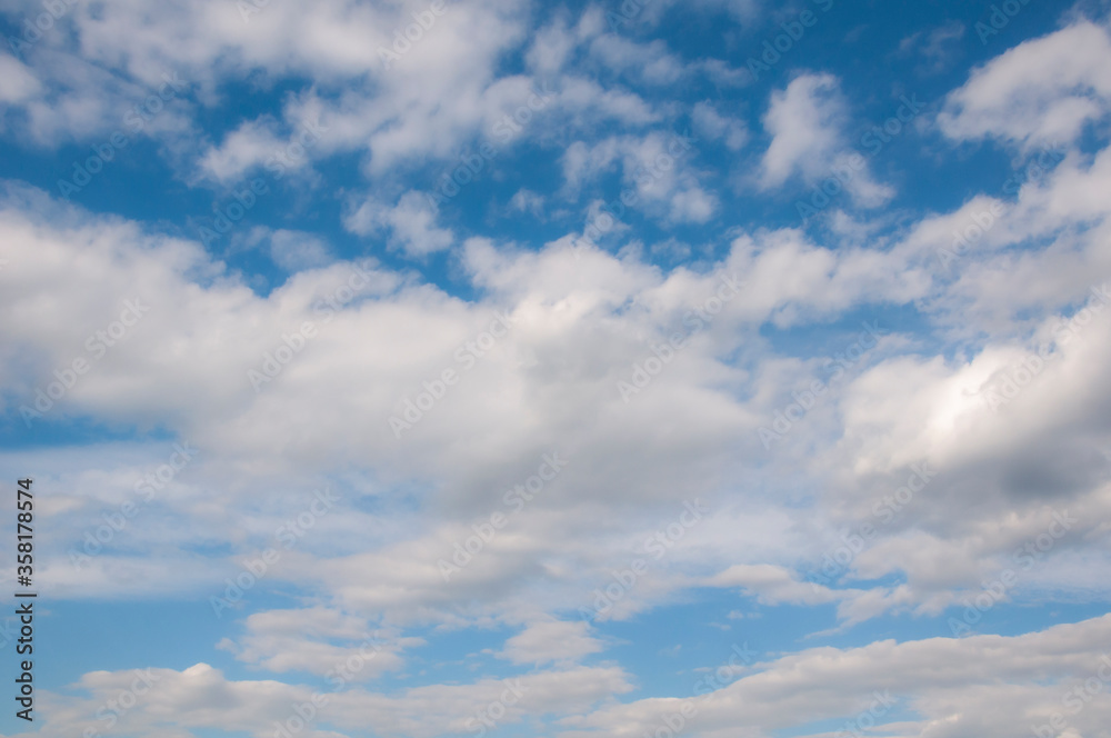 White clouds on a blue sky. Beautiful natural background. White clouds on a blue sky. Beautiful natural background.