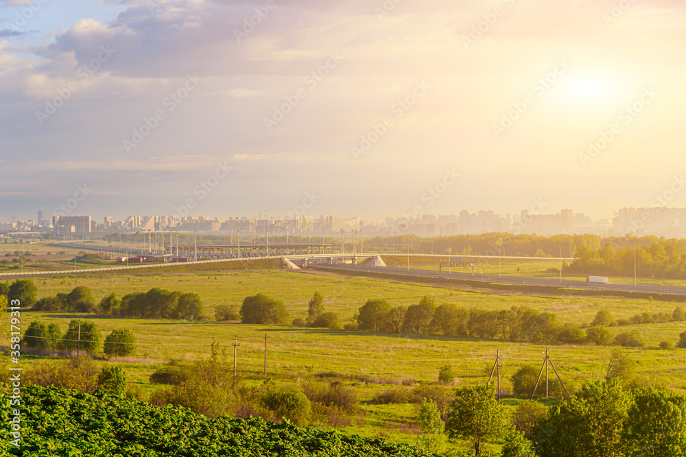View of the toll road. View of the road. City view. Summer landscape. The morning dawn. Sunlight. M11 Russia.