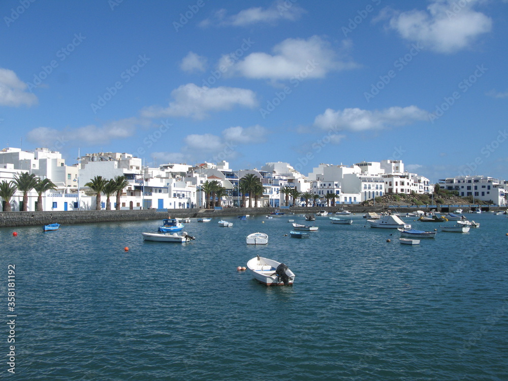 Charco de San Ginés - blue lagoon surrounded by white houses under blue sky, Arrecife, Lanzarote, Canary Islands, Spain