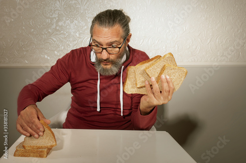 elderly man plays with bread